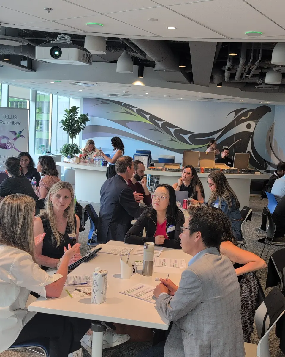 Owners working in small groups at tables during an Execution Lab session